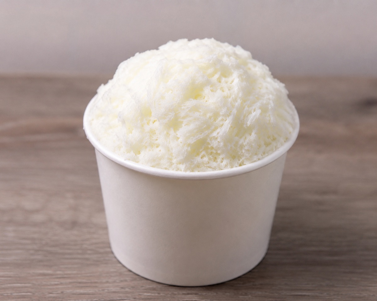 A cup of Greek Snow — a soft, snow-like cultured frozen dessert made from authentic Greek yogurt, kefir and collagen, served in a white tub